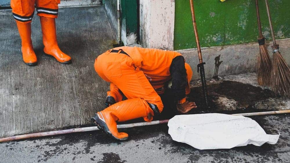 A worker in high-visibility gear inspects a Chicago sewer tunnel, managing wastewater infrastructure in Cook County, IL