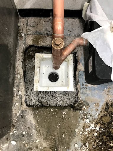 High-pressure water stream clearing debris from a Chicago sewer line to restore full drainage flow in Cook County, IL